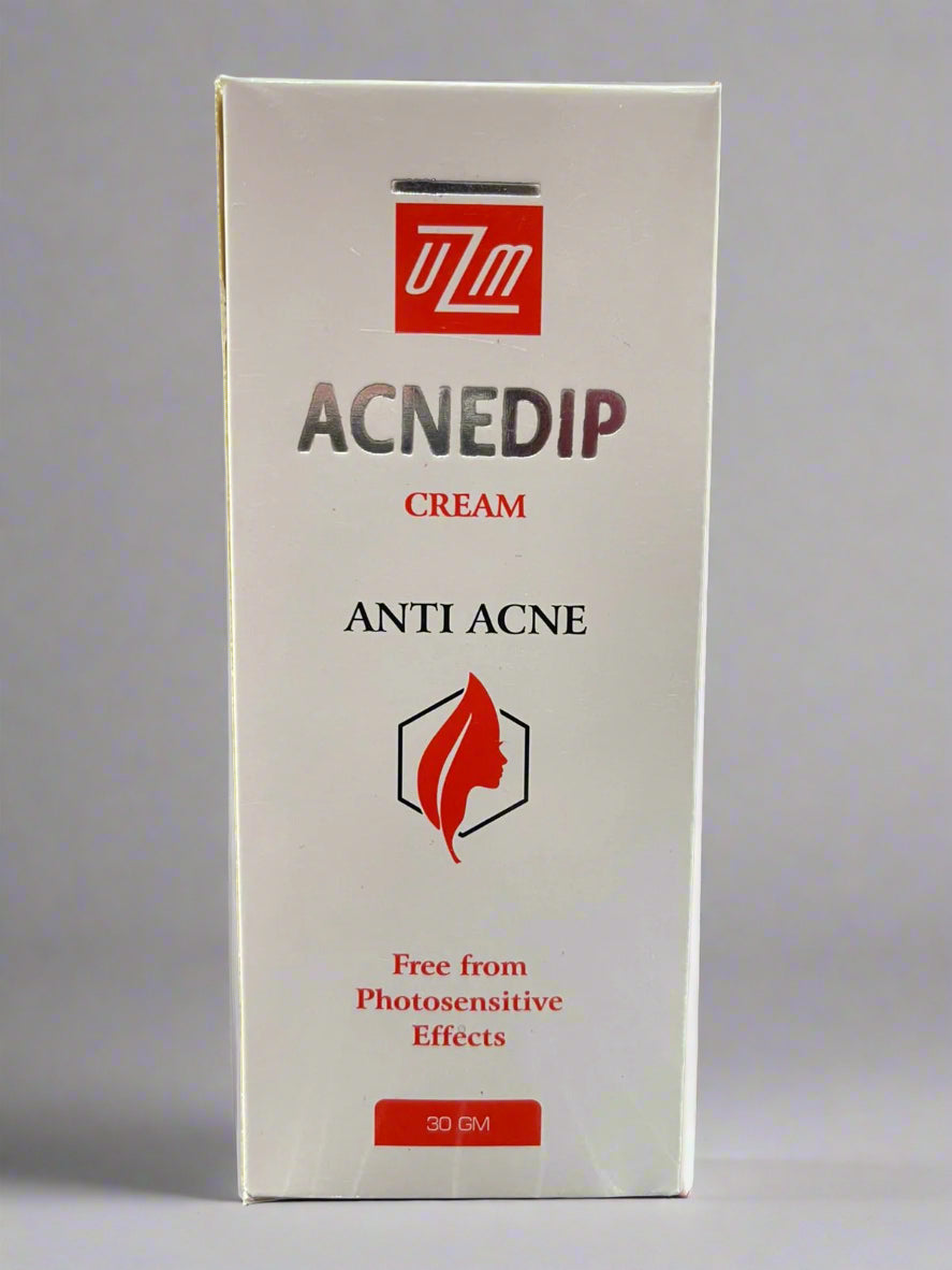 Box of Acnedip cream with UZM logo on a gray background
