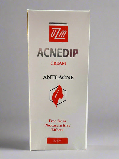 Box of Acnedip cream with UZM logo on a gray background